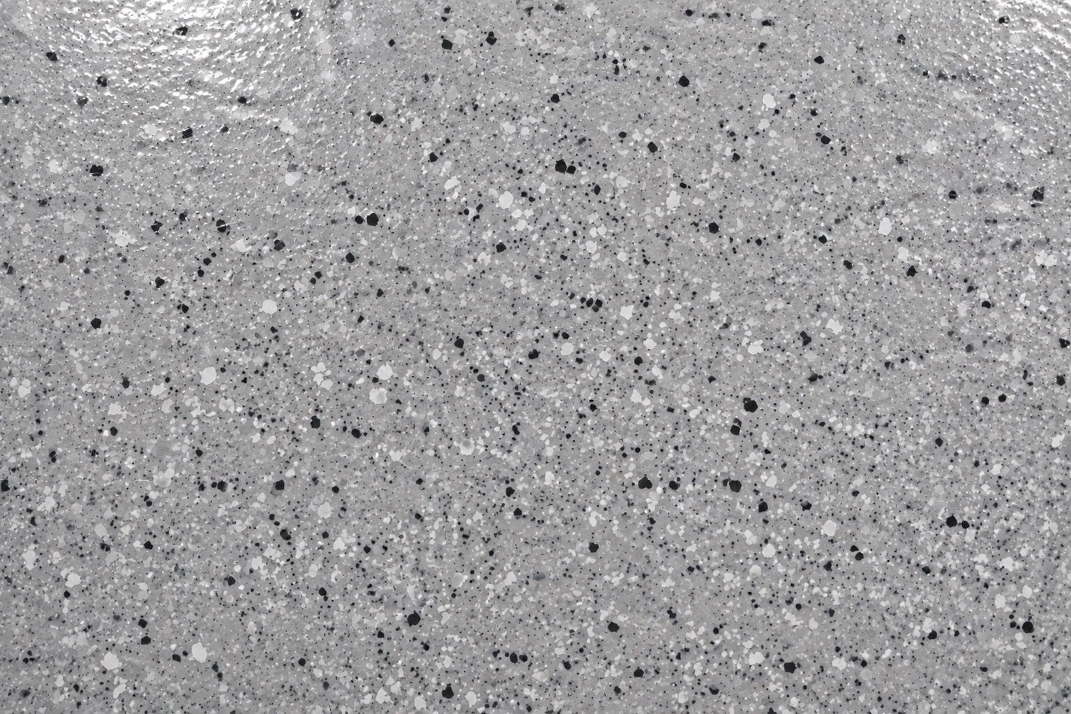 Close-up of a gray, black, and white full-flake polyaspartic floor finish