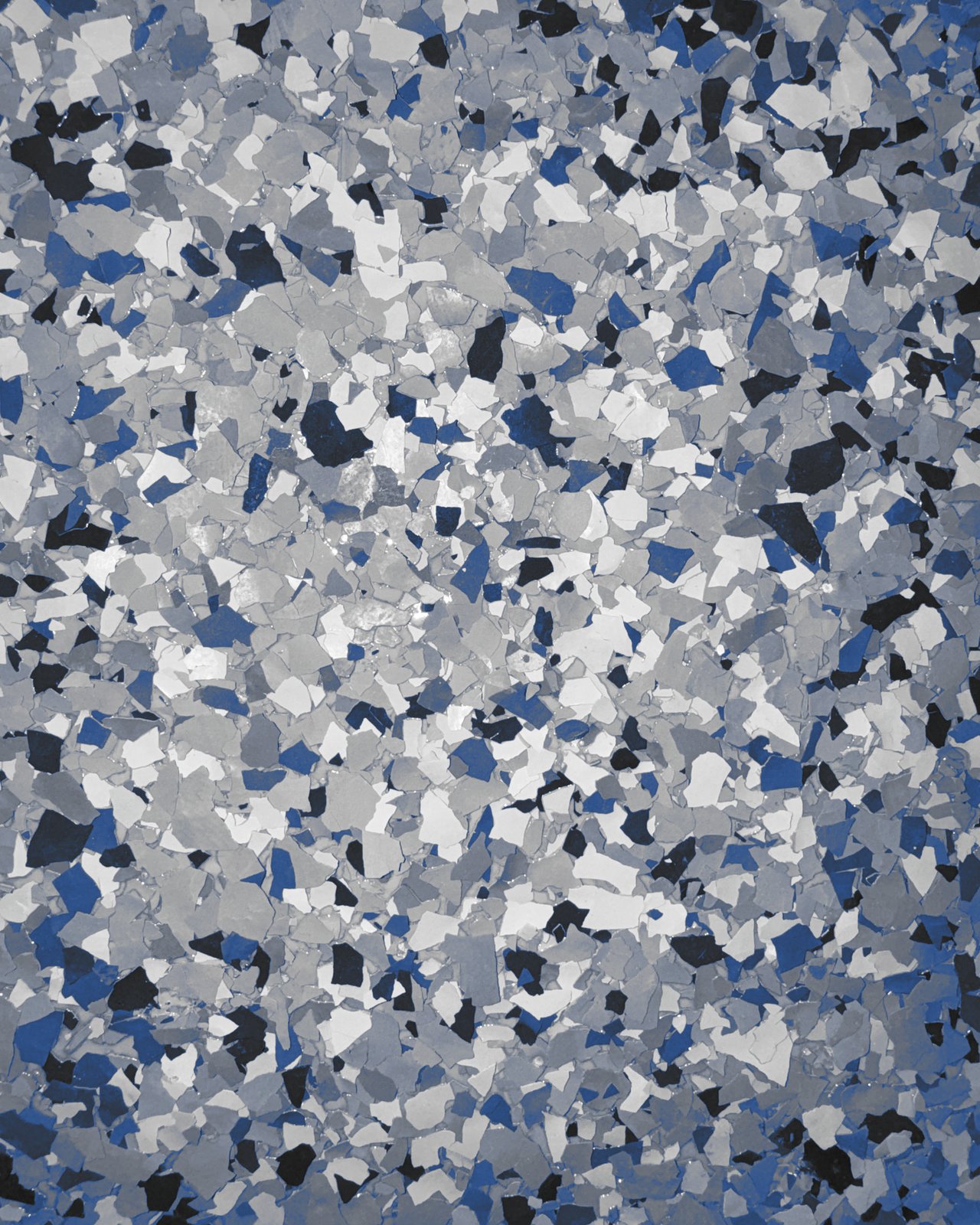 Close-up of a blue, gray, white, and black full-flake epoxy floor finish
